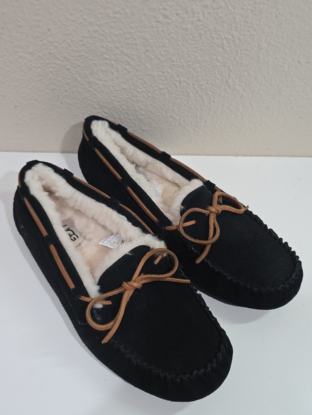 UGG Black Moccasin Slippers with Tan Bow Trim
